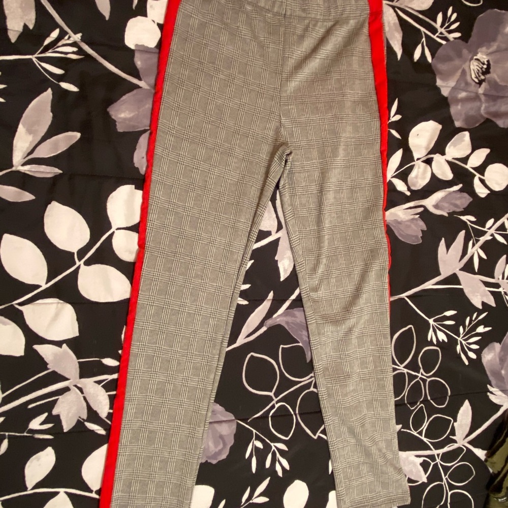 Black and white pants with red on the sides